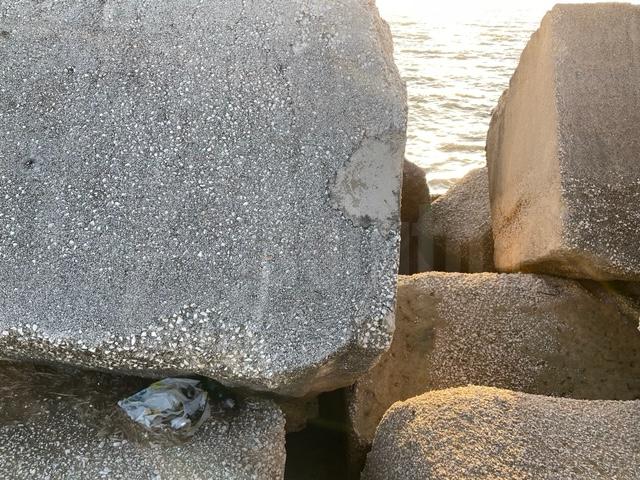 Menfi, rifiuti ancora integri tra le pietre quadrate del molo di Porto Palo