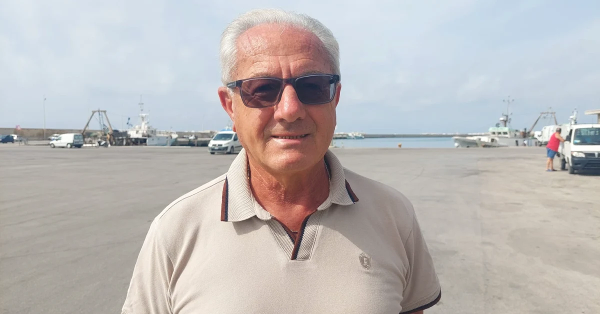 Mercato del pescatore chiuso a Sciacca, struttura in legno vuota al porto con anziani riparati dal sole